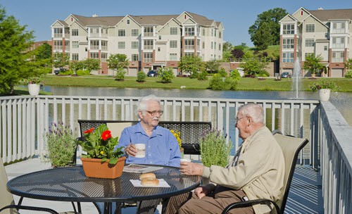 residents enjoying coffee on the patio at st clair lake asbury place maryville